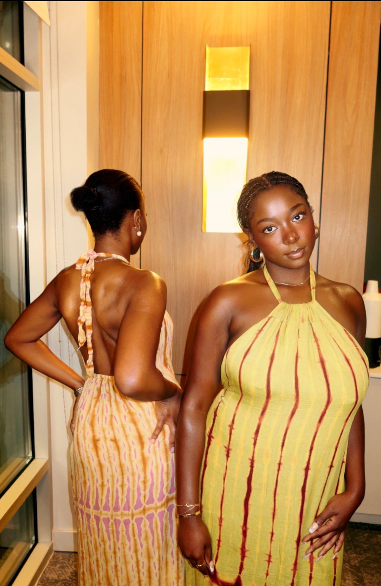 Open back of the Blush Sand Belle de Dos dress beside a model in Citron and Burgundy