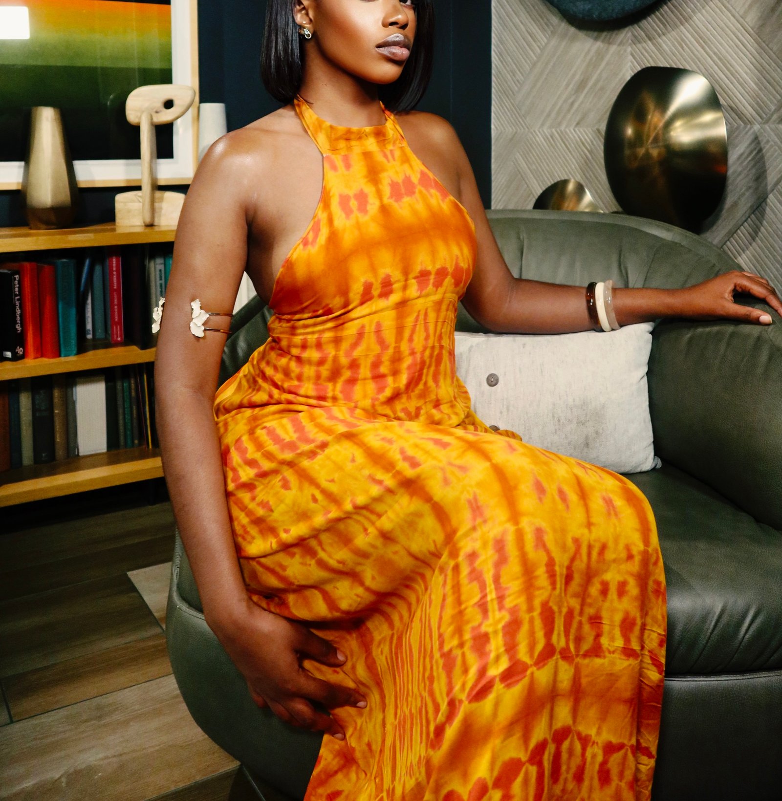 Close view of the orange tie-dye halter bodice and skirt of the Belle de Dos dress